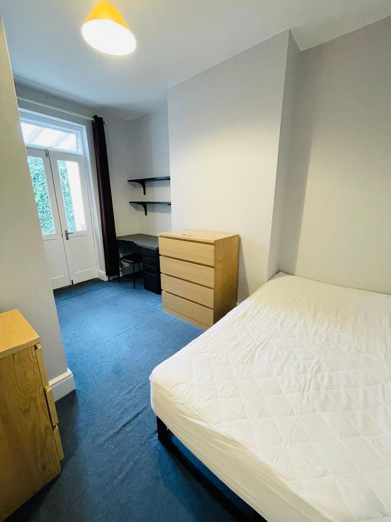 Bright, neatly presented bedroom with a double ...