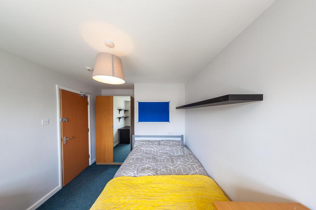 Neat single bedroom with a comfortable bed dres...