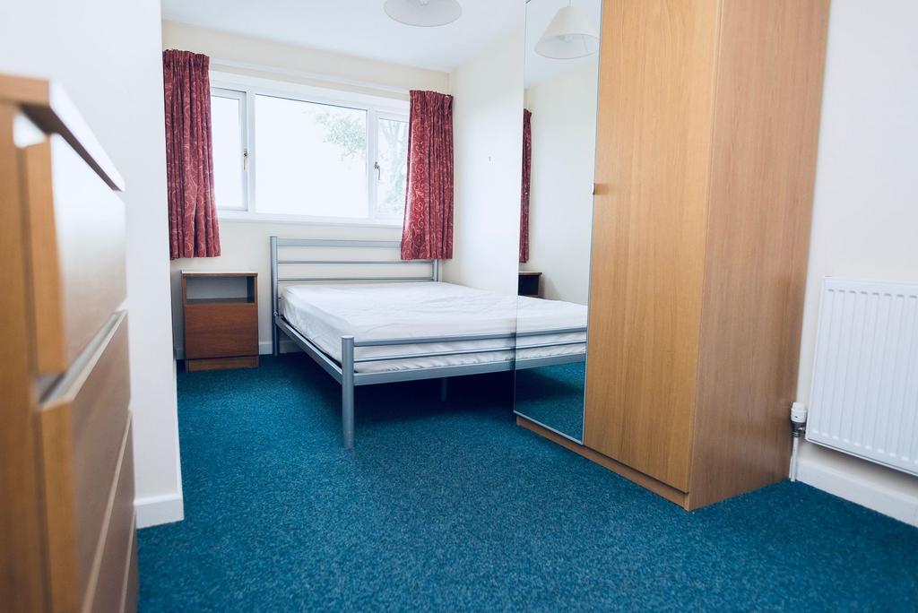 Bright, tidy bedroom with a double bed frame, l...