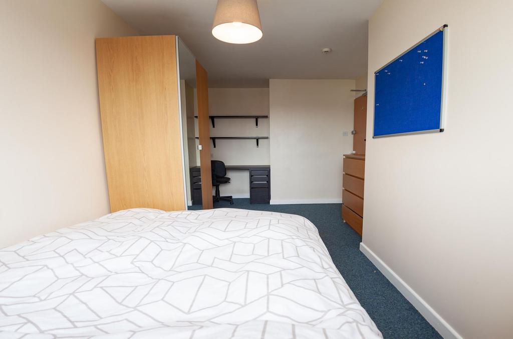 Bright, simply furnished double bedroom with a ...