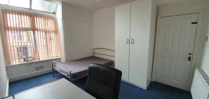 A bright and tidy single bedroom featuring a la...