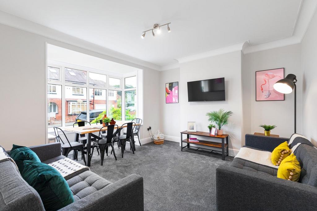 Bright, modern living room with large bay windo...