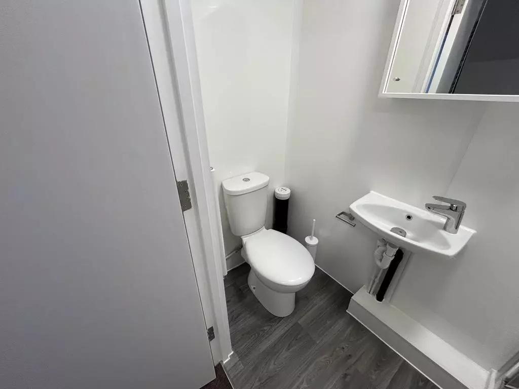 Compact modern bathroom with white sanitaryware...
