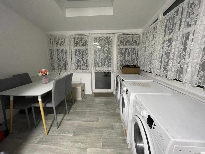Bright, tidy communal room with large windows, ...