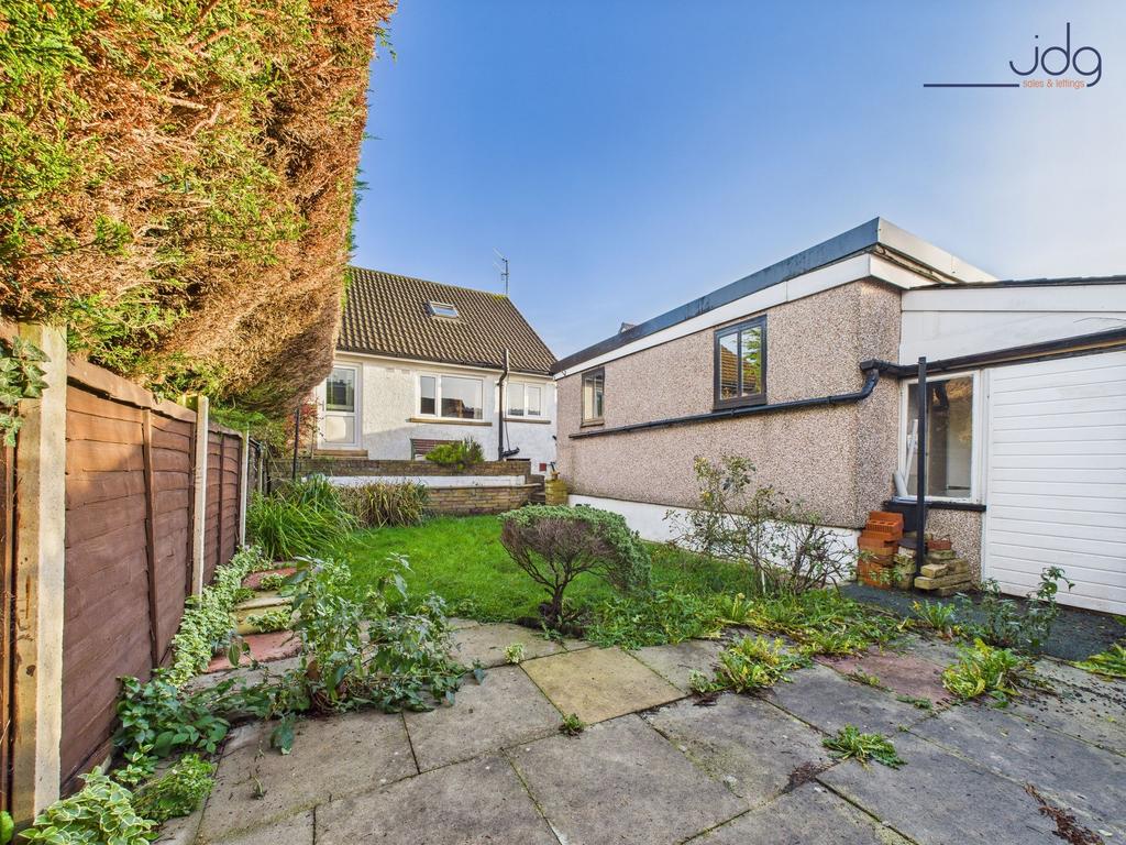 A mixture of flag and lawn garden with garage...