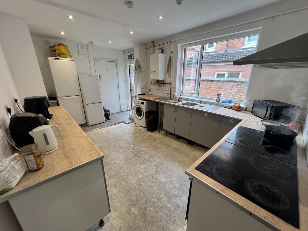 Long communal kitchen with two long worktops, m...