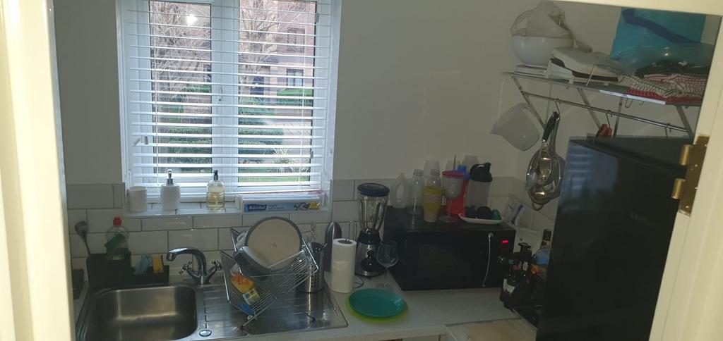 Compact kitchen with a window over the sink, ti...