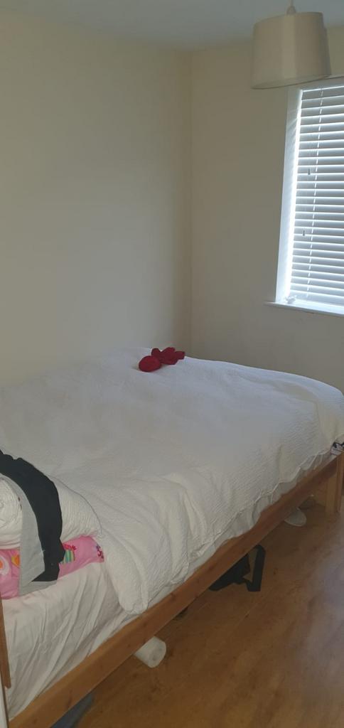 Bright, simply furnished bedroom with a comfort...