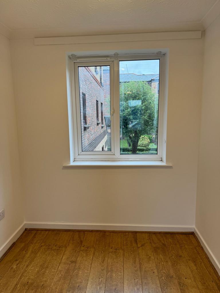 Bright, freshly painted single bedroom with a l...