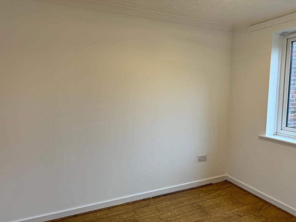 Bright, freshly painted single bedroom with woo...