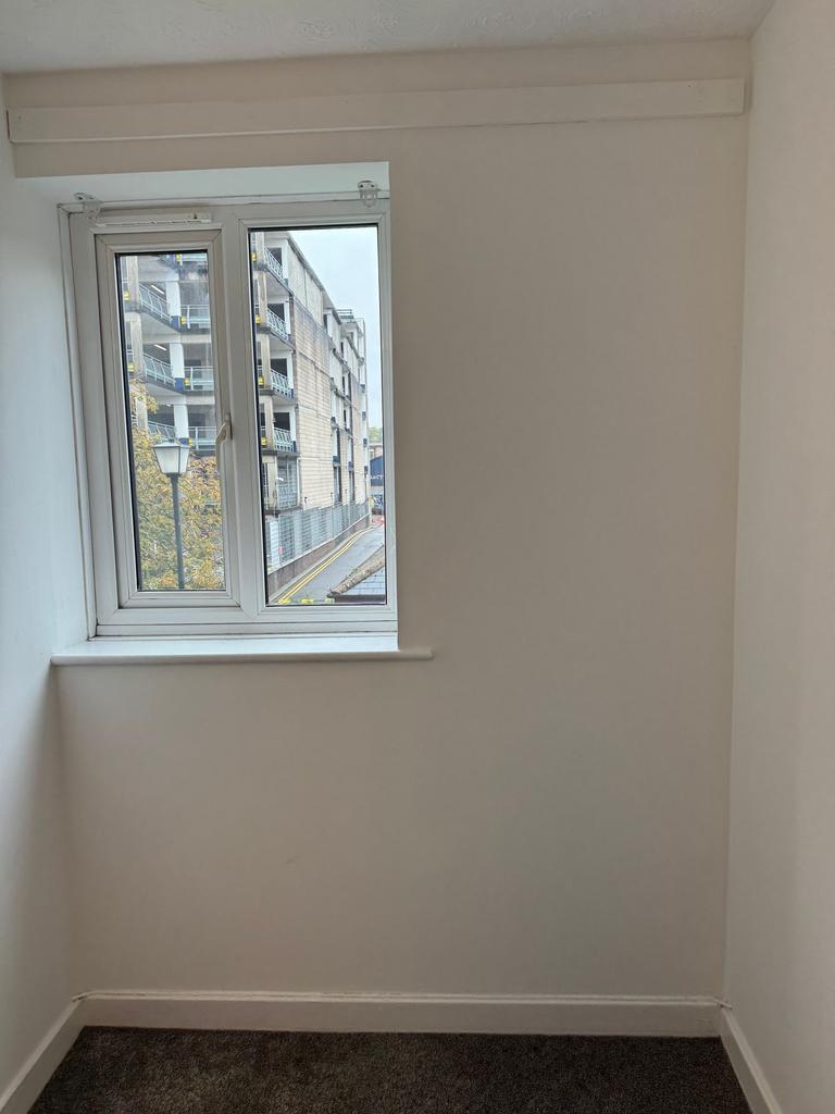 Bright, freshly painted small room with a stree...
