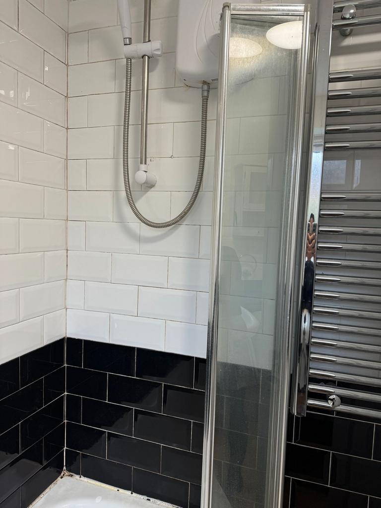 Modern tiled bathroom shower with contrasting w...