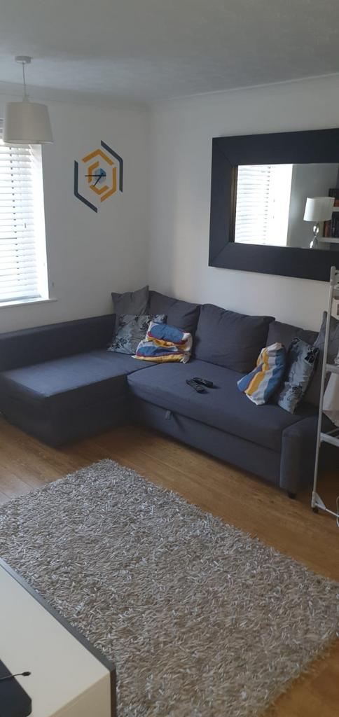 Bright, modern living room with a large L-shape...