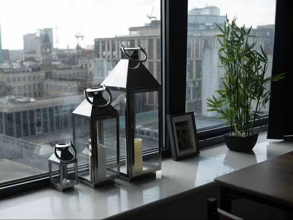 Bright city-view window with decorative lantern...