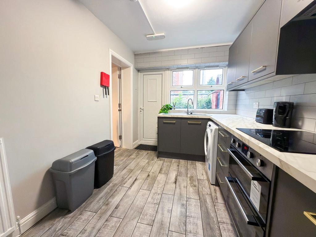 Bright, modern kitchen with grey shaker cabinet...