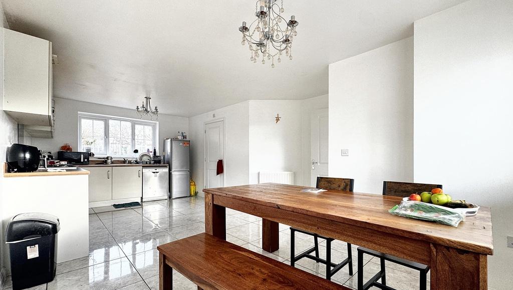 Bright, open-plan living and dining area with m...