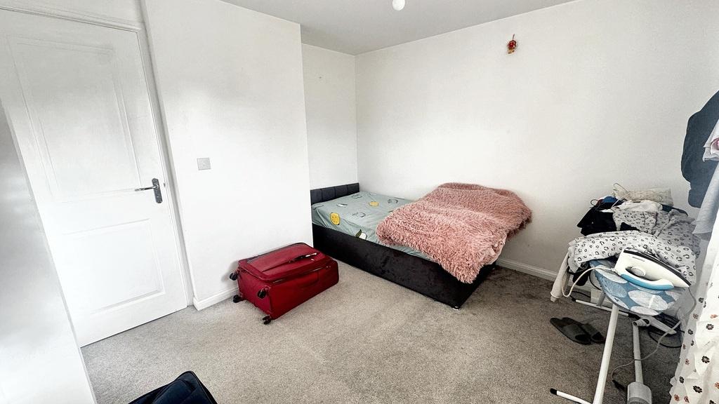 Bright, simply furnished bedroom with a single ...