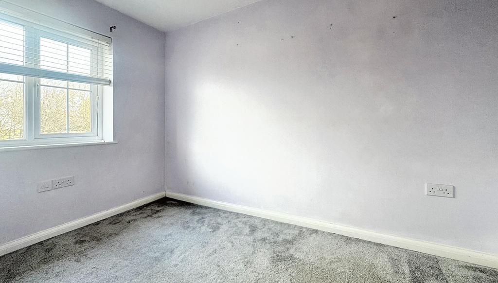 Bright single bedroom with a large window letti...