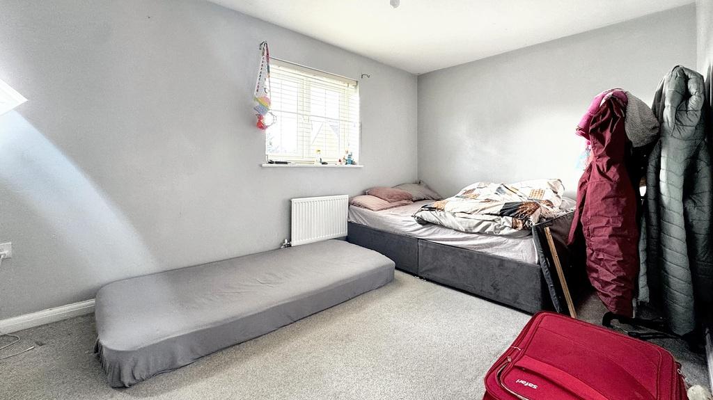 Bright single bedroom with a large window, neut...