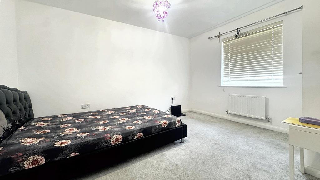 Bright, uncluttered double bedroom with neutral...