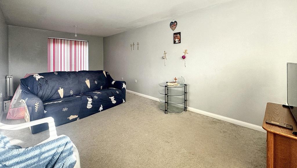 Bright, neutrally decorated living room with a ...