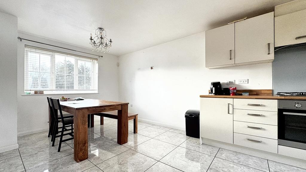 Bright, modern kitchen with tiled floors, a fit...