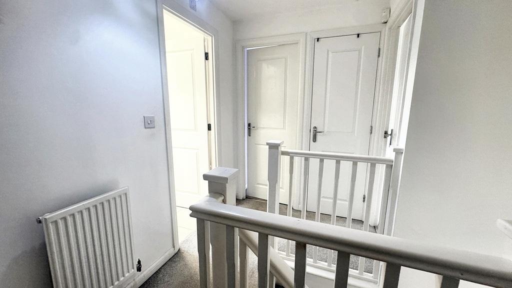 Bright, freshly painted upstairs landing with c...