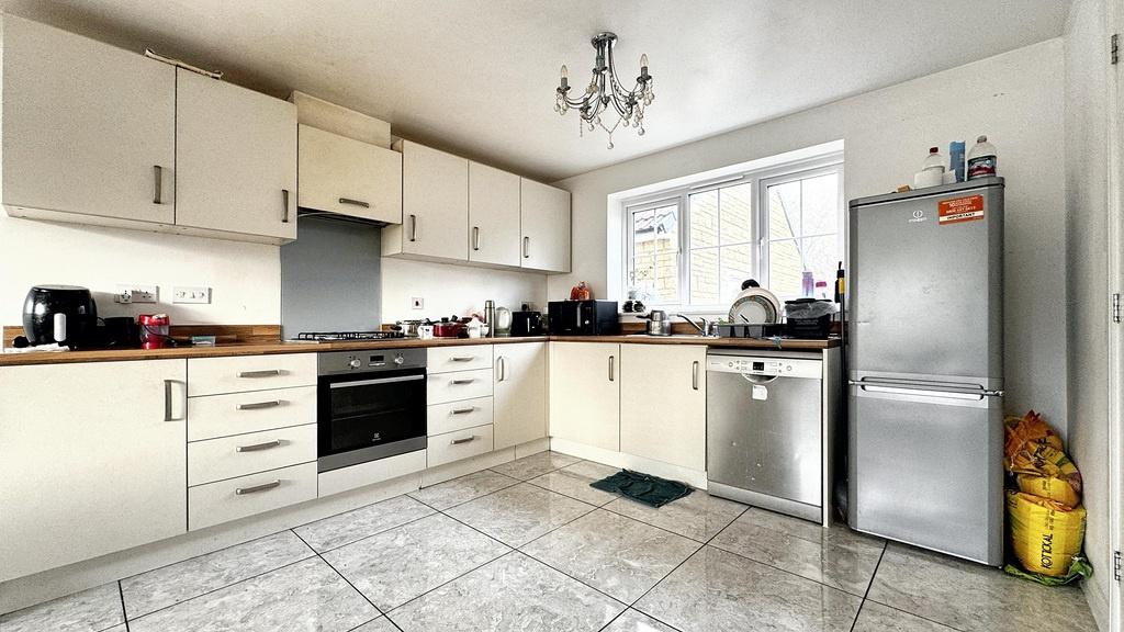 Bright, modern kitchen with ample cabinetry, in...