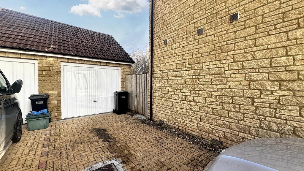 Paved driveway leading to a single garage with ...