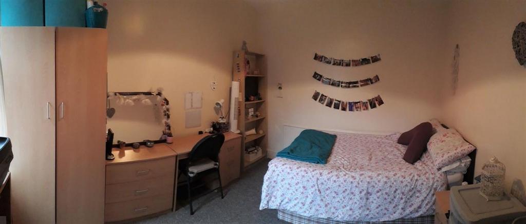 Bright, comfortable double bedroom with a made ...