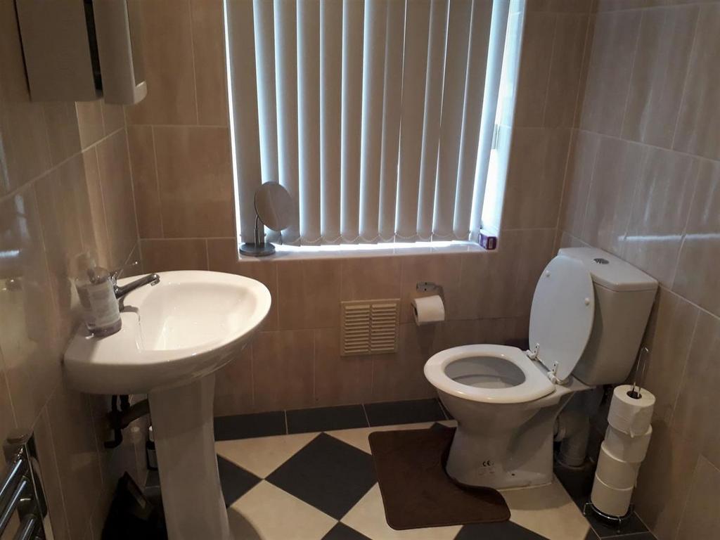 Well-maintained bathroom with pedestal sink, to...