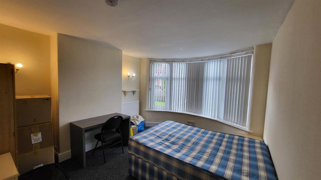 Bright double bedroom with a large bay window a...