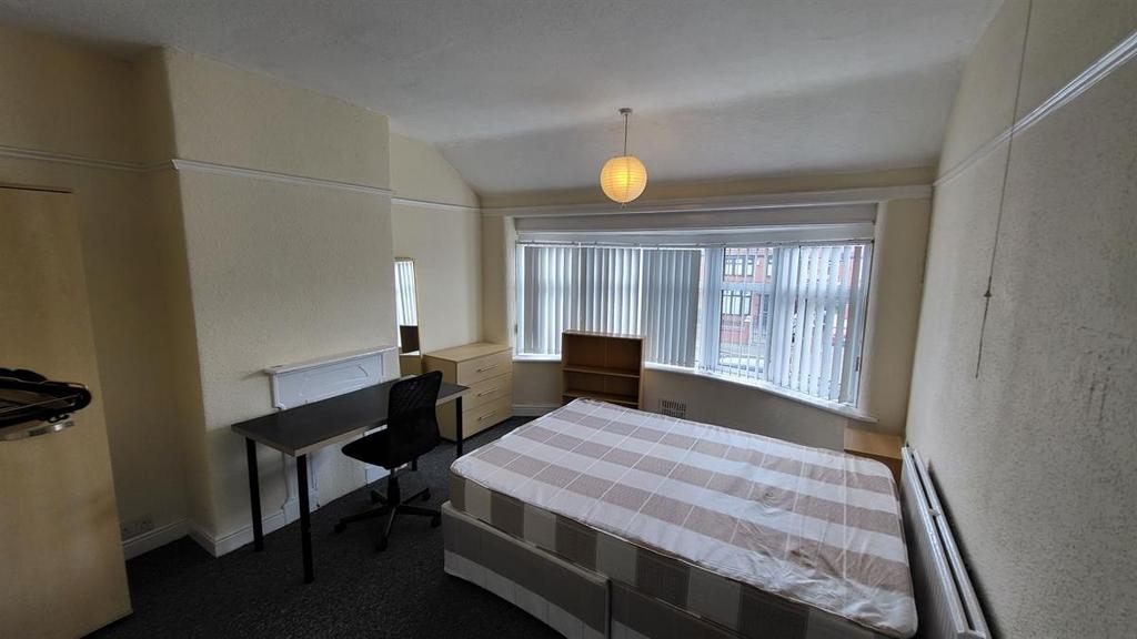 Bright double bedroom with a large front window...