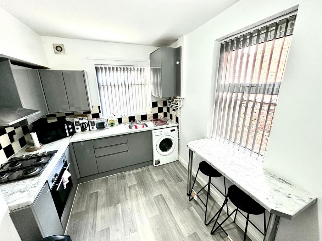 Bright modern kitchen with grey fitted cabinets...