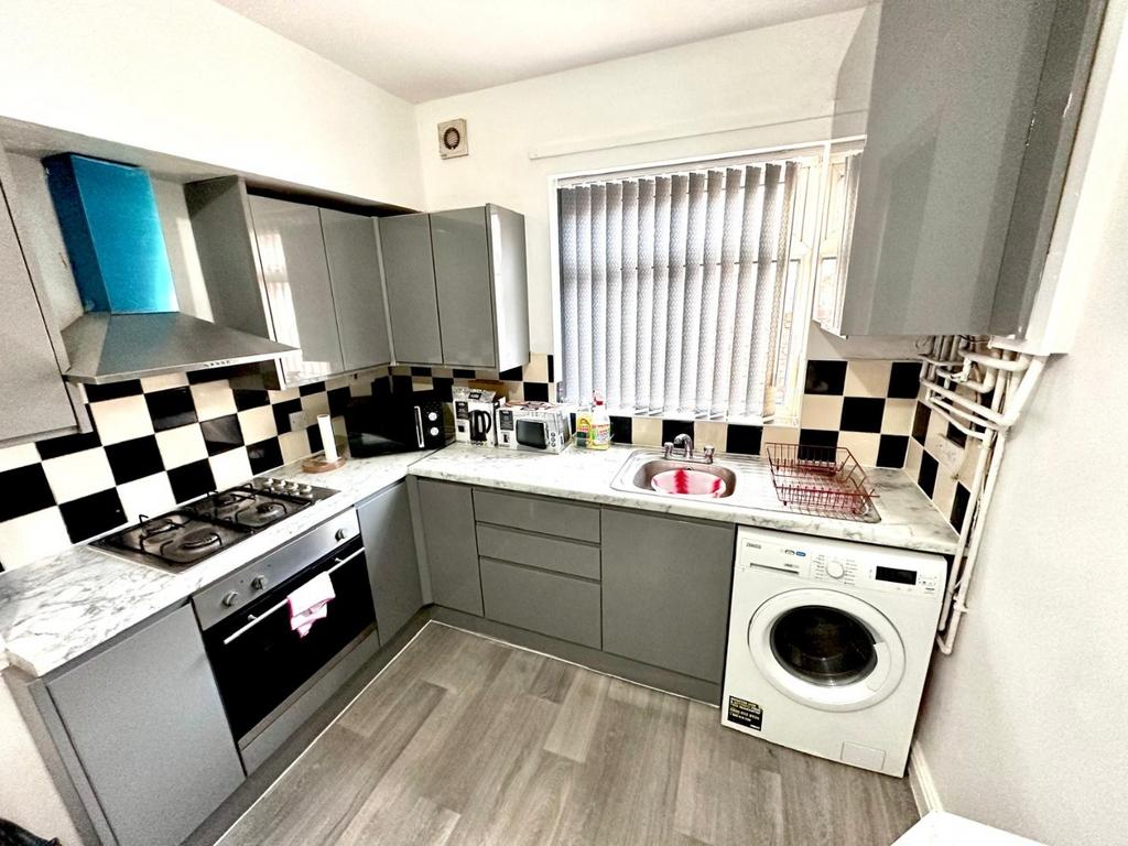 Modern fitted kitchen with grey cabinets, check...