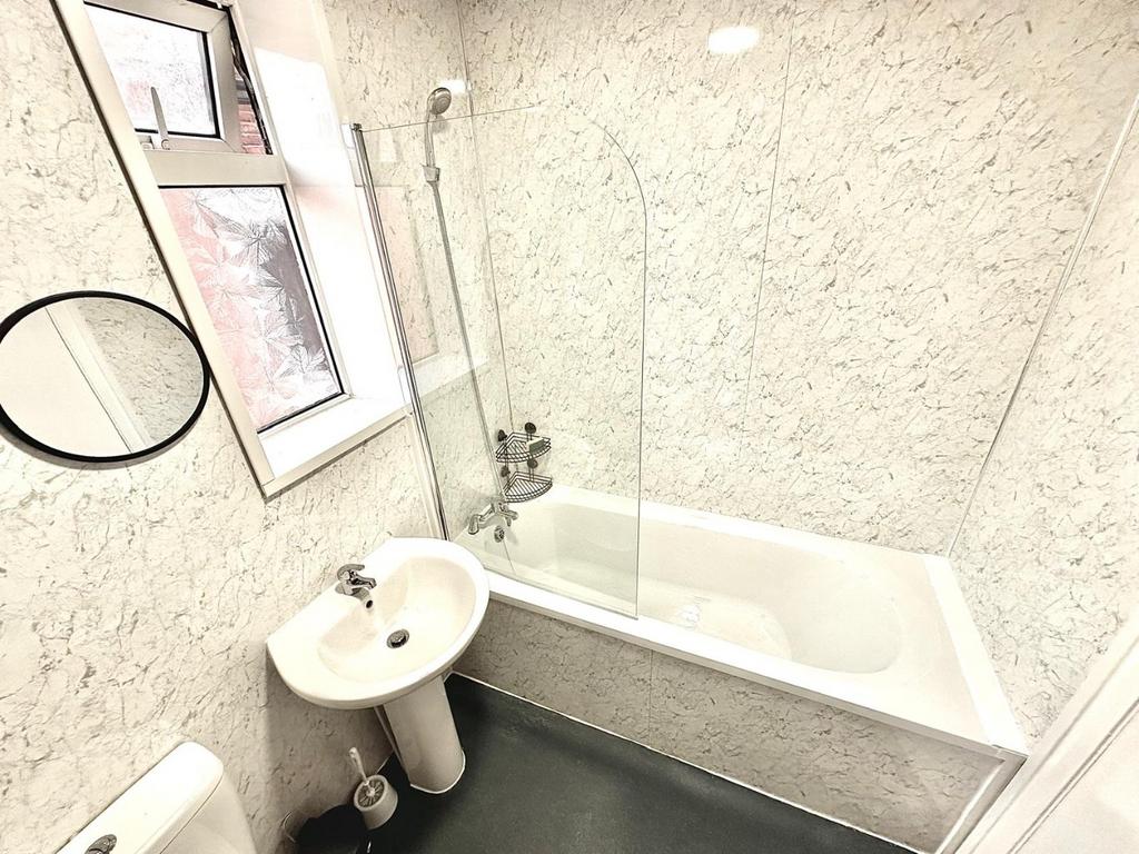 Bright, modern bathroom with a full-size bath a...