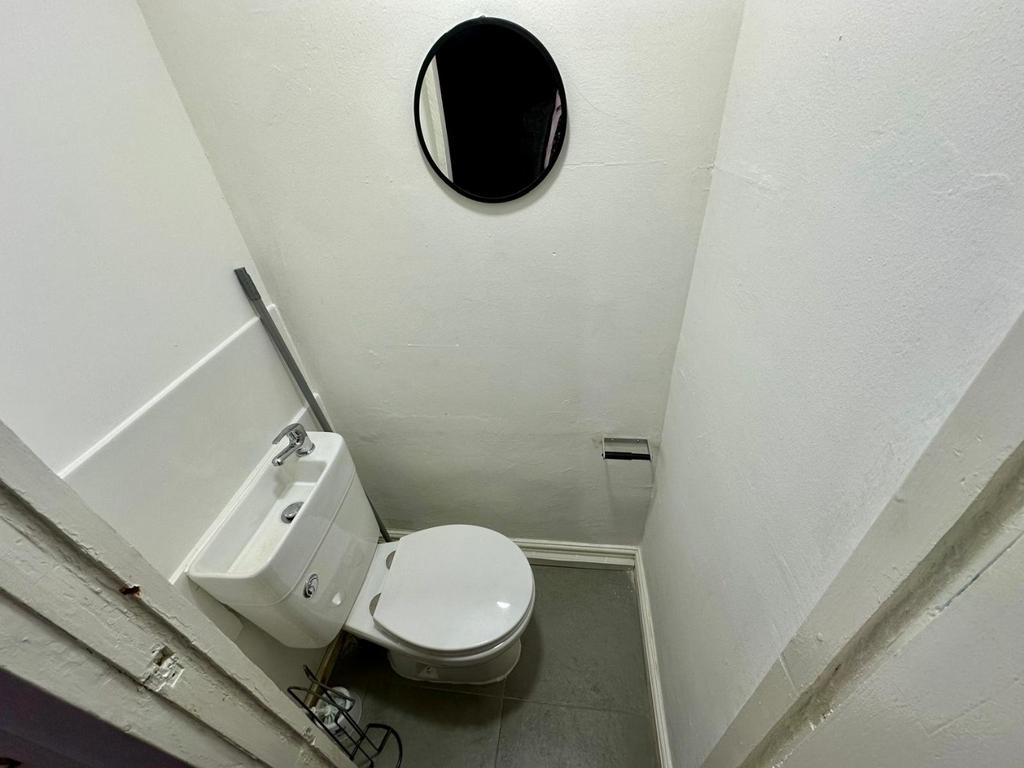 Compact, well-kept WC with a modern toilet, wal...