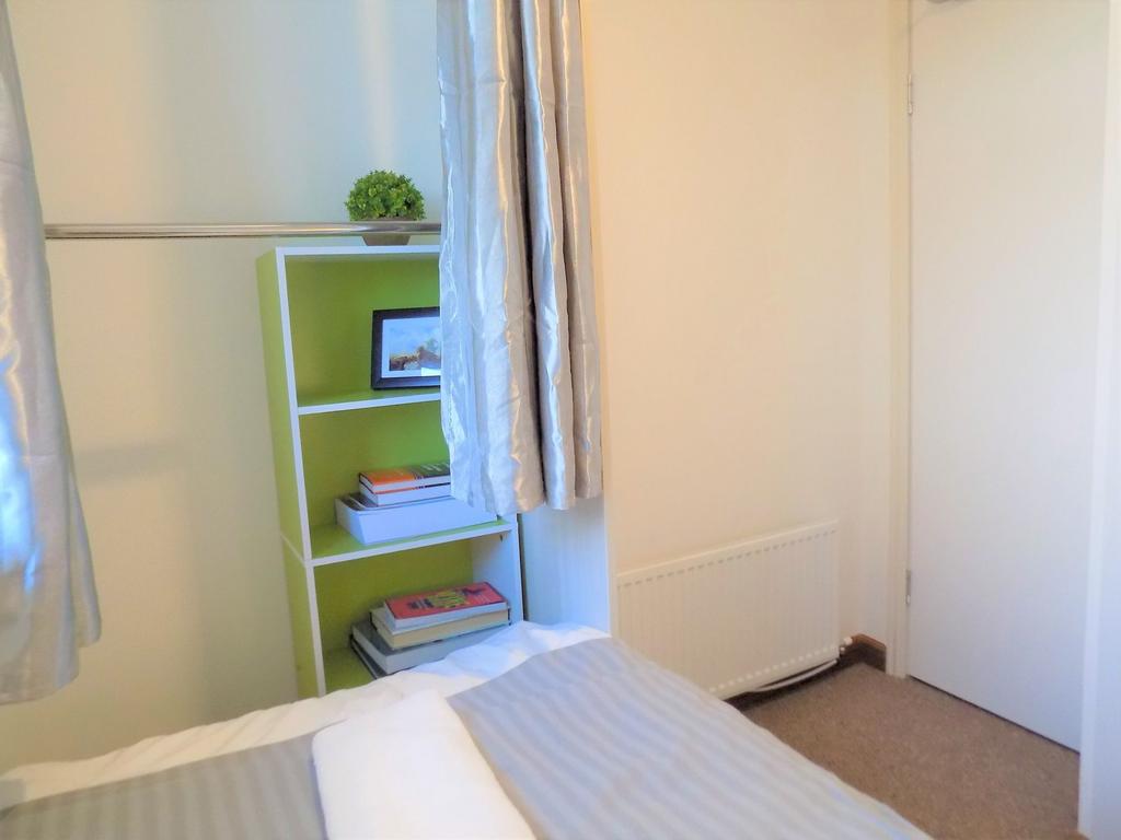 Bright, tidy bedroom with neutral decor and tas...