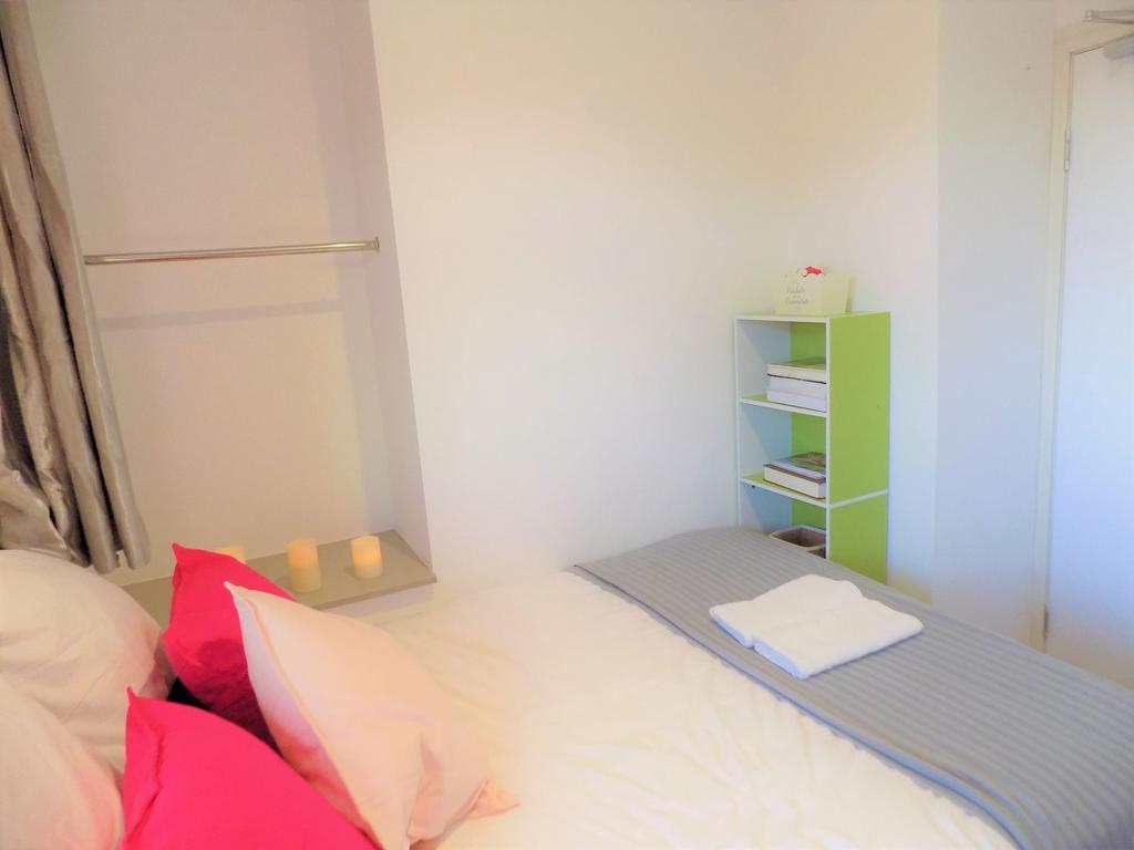 Bright, neatly presented bedroom with a made do...