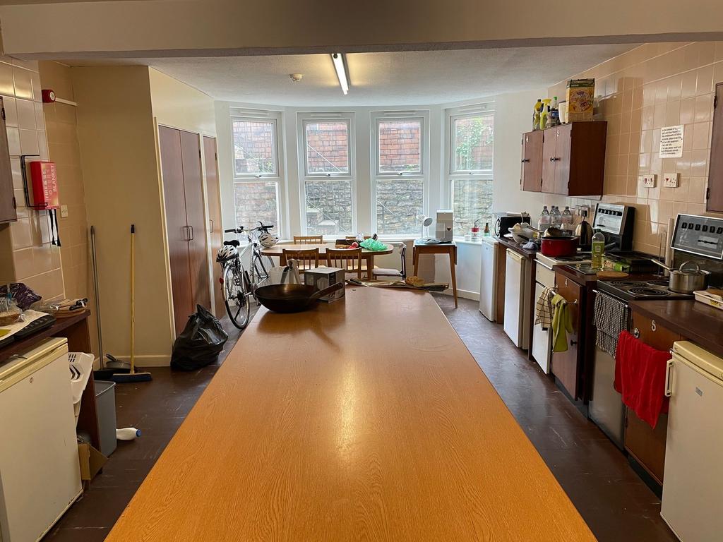 Bright, communal kitchen/dining space with a lo...