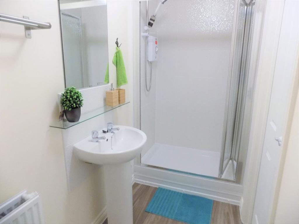 Bright, modern bathroom with a walk-in shower, ...