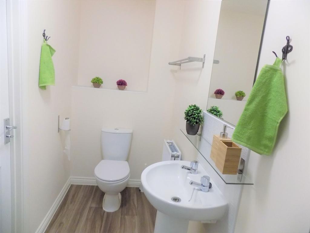 Bright, modern bathroom with clean white sanita...