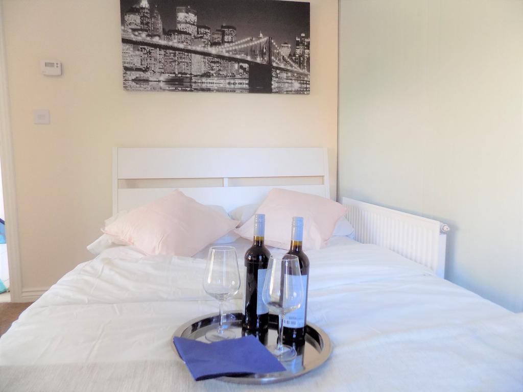 Bright, tidy double bedroom with a white headbo...