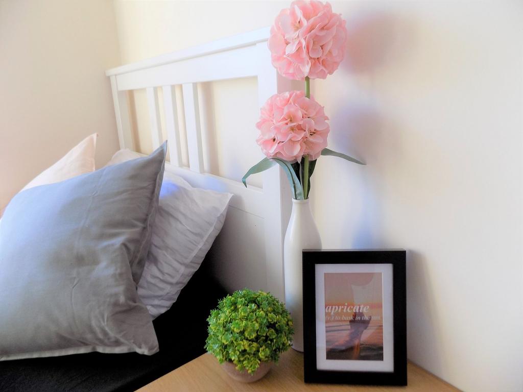 Bright, neatly styled bedroom corner with a whi...