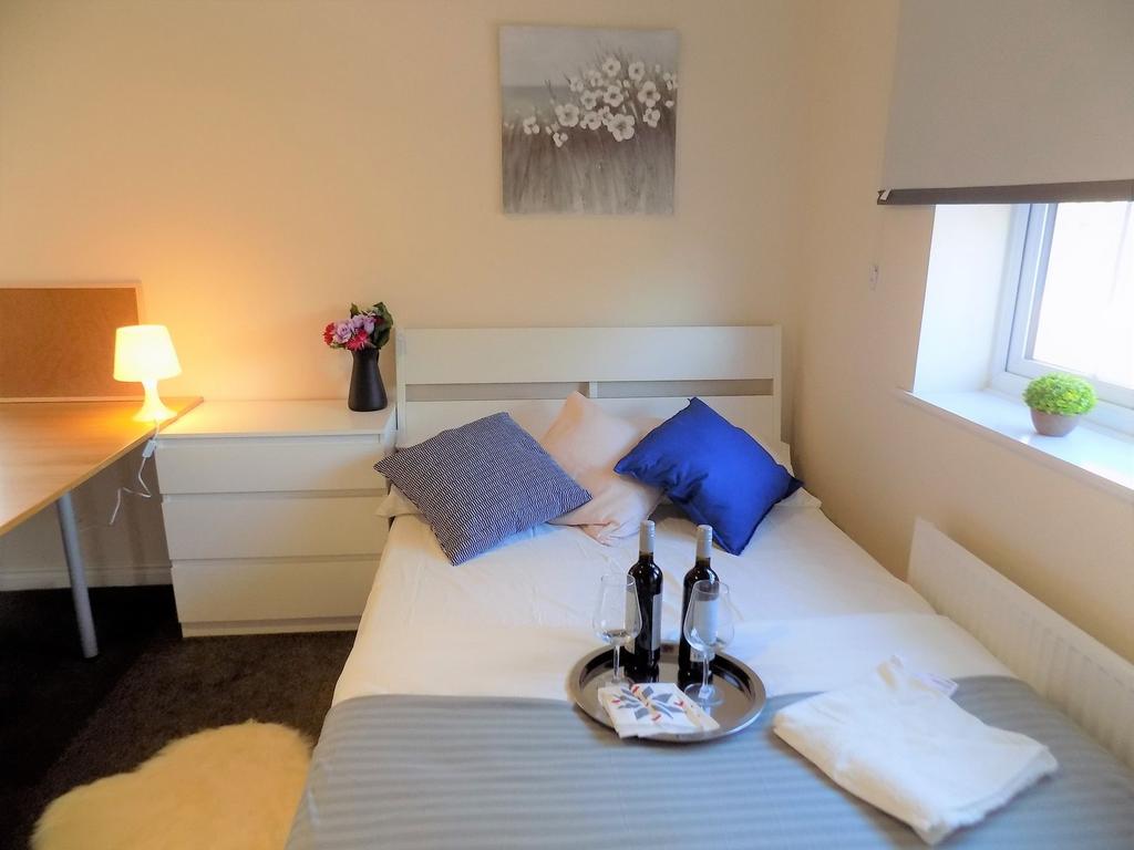 Bright, neatly styled bedroom with a comfy bed ...