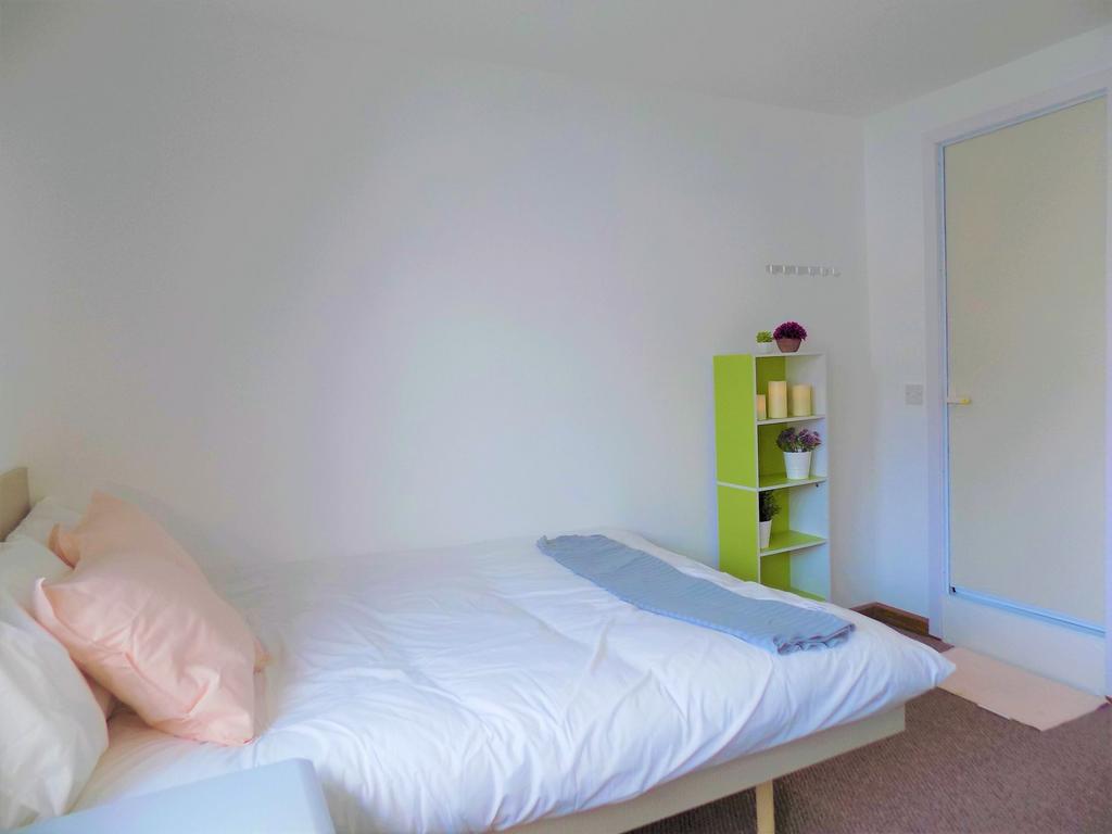 Bright, tidy bedroom with a made double bed, so...