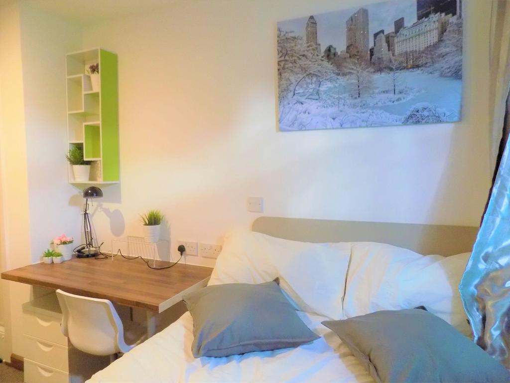 Bright, neatly-arranged bedroom with a comforta...