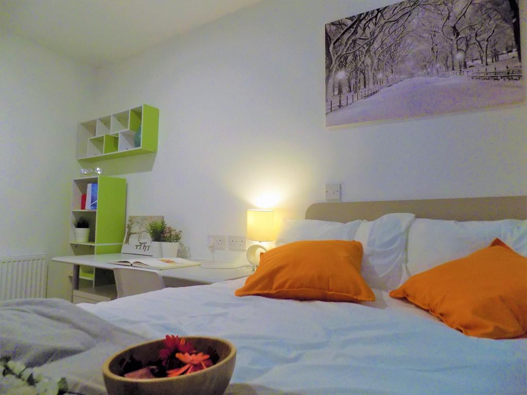 Bright, neatly styled bedroom featuring a comfy...