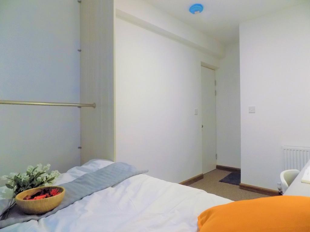 Bright, minimally-styled single bedroom with a ...