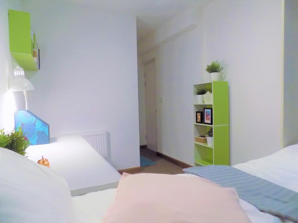 Bright, neatly styled bedroom with a comfortabl...